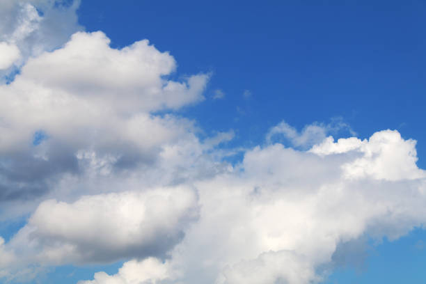 Photo of big puffy fluffy cumulus clouds cloudscape cloud and bright blue sky