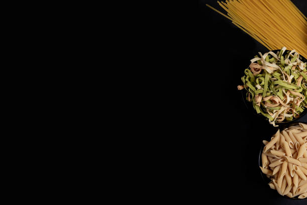 Various pasta. Cooking concept. Top view on dark beton background wuth copy space.