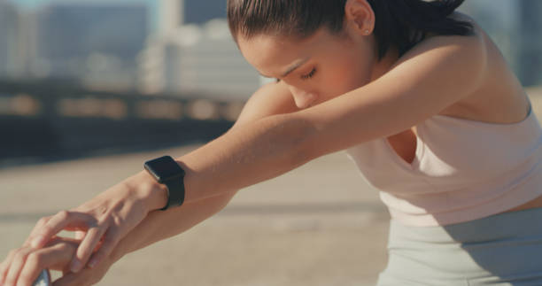 istock Shot of a young woman taking a break to stretch before a workout 1347576385