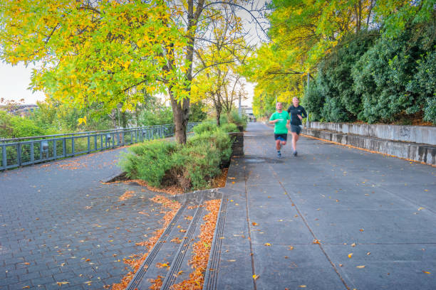 Men exercise on the Eastbank Esplanade in Portland Oregon USA on a sunny day.