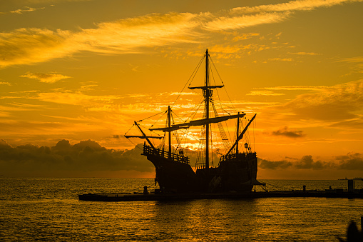 A Spanish Galleon docked at sunrise.