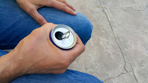 A man holds an aluminum can with a drink, close-up. A man holds an aluminum can with a drink, close-up. energy drinks stock pictures, royalty-free photos & images