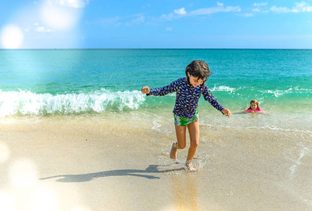 istock Happy children running and playing on an idyllic sunny beach 1347591098