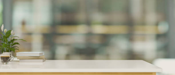 istock Close-up Copy space on white worktable over blurred office room in background. 1347591753