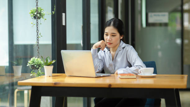 istock Female working on her laptop computer, thinking and ponder on her strategy ideas 1347591874