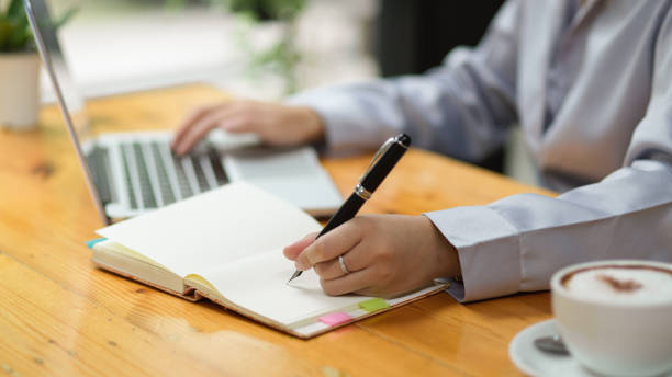istock Businesswoman taking some notes, jotting down business information 1347591892