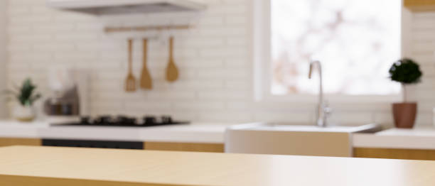 istock Wooden dining table top for montage over blurred modern contemporary kitchen space 1347591962
