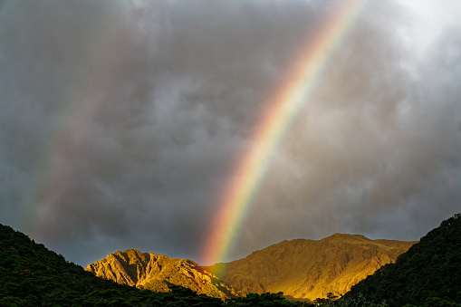 Double rainbow above Boyle Flat Hut at sunrise, St James Walkway, Lewis Pass, south island, New Zealand.