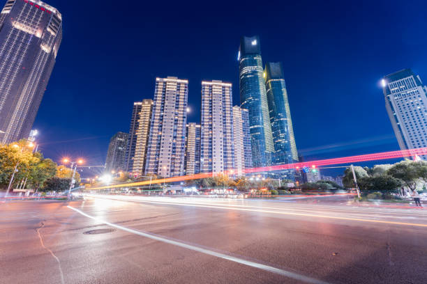istock Car lights passing fast in the city night scene 1347594062