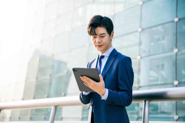 istock Young businessman working with digital tablet outdoor 1347595133