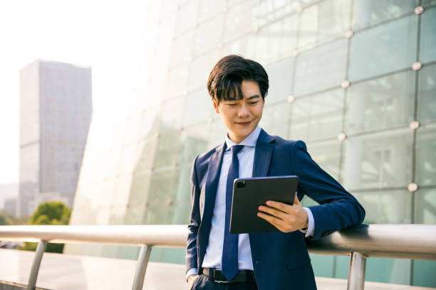 istock Young businessman working with digital tablet outdoor 1347595148