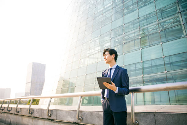 istock Young businessman working with digital tablet outdoor 1347595198