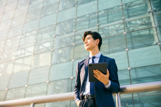 istock Young businessman working with digital tablet outdoor 1347595237