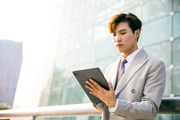 istock Young businessman working with digital tablet outdoor 1347595284