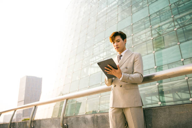 istock Young businessman working with digital tablet outdoor 1347595292