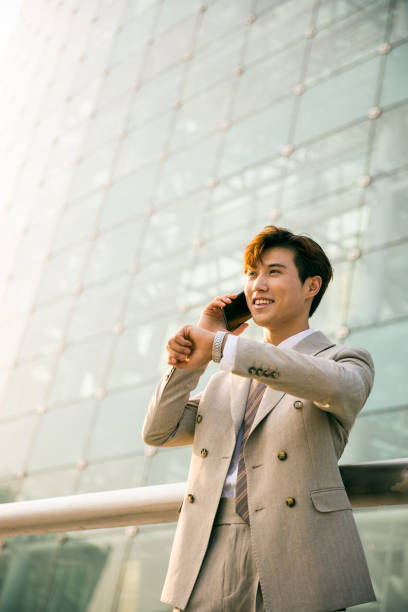 istock Businessman talking on mobile phone outside 1347595852