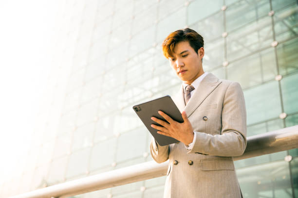 istock Young businessman working with digital tablet outdoor 1347595864