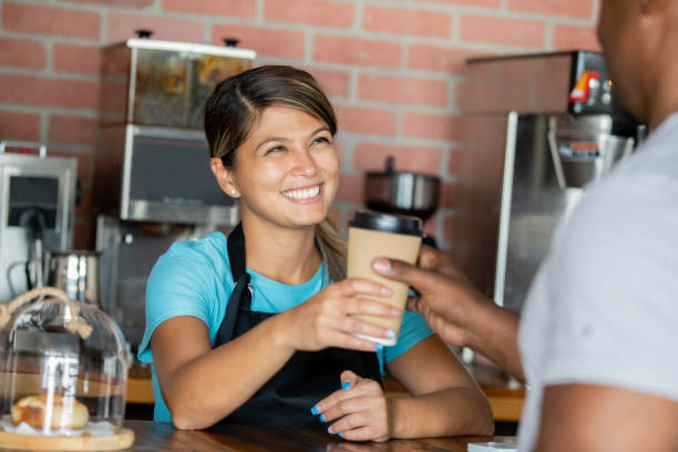 istock Happy Barista holding coffee 1347598343