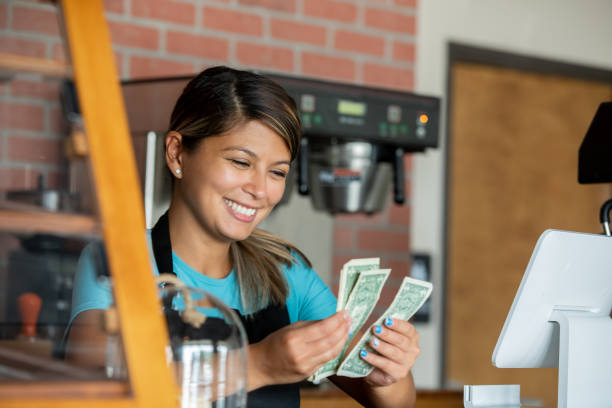 istock Barista counting money at checkout 1347598352
