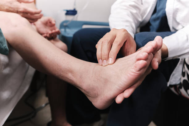 medical doctor taking patient's pulse in the foot medical doctor taking patient's pulse in the foot foot stock pictures, royalty-free photos & images