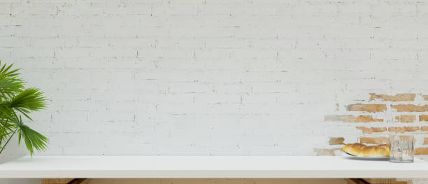 istock Close-up Copy space on white table top for montage product display over white brick wall background. 1347601440