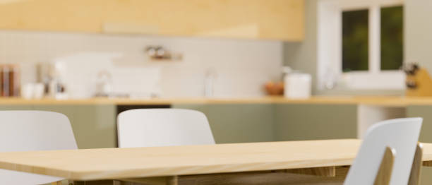 istock Modern wooden dining table with space on top for montage over blurred stylish kitchen interior in background 1347601441