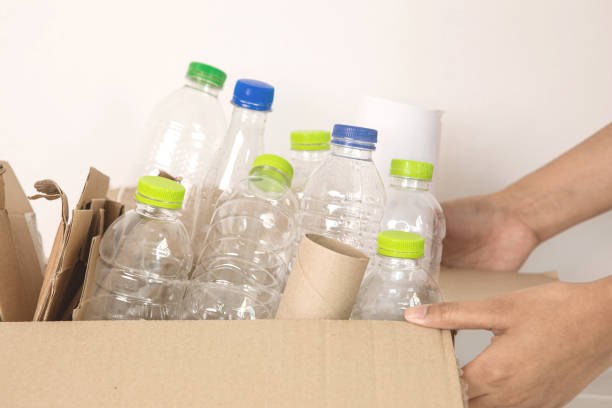 istock hand holding plastic bottle waste for sorting  plastic bottle and paper garbage waste to proper recycling box , recycle or reuse to take care an environment concept 1347603410