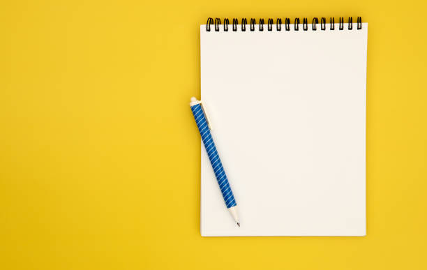 istock spiral notepad book paper with a blue pen placed on yellow background for creative thinking concept 1347605013
