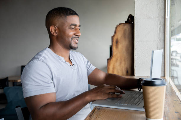 istock Man telecommutes from coffee shop in his neighborhood 1347607222