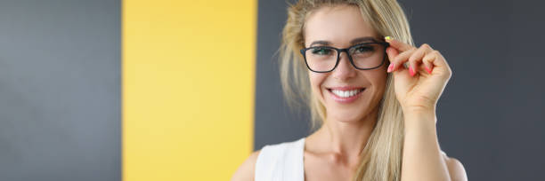 istock Slim young woman adjusts glasses for vision 1347610650