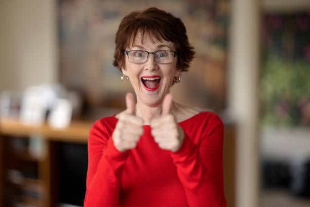 istock Happy woman with two thumbs up 1347610673