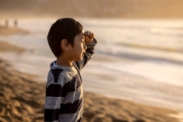 High quality stock photos of an Asian American family enjoying a walk on the beach during Sunset.