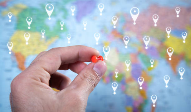 istock Male hand showing push pin. Gps concept on world map background. Location 1347612969
