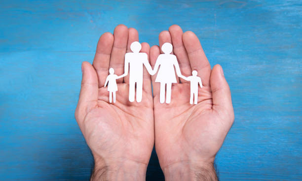istock Human hands showing paper cut family. 1347612988