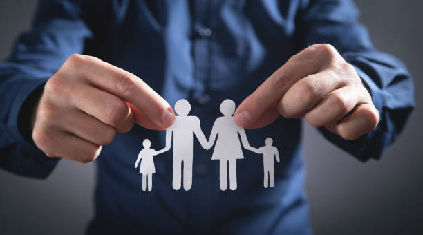 istock Human hands showing paper cut family. 1347612990