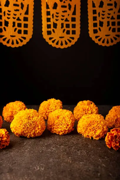 Cempasuchil orange flowers or Marigold. (Tagetes erecta)  and Papel Picado. Traditionally used in altars for the celebration of the day of the dead in Mexico