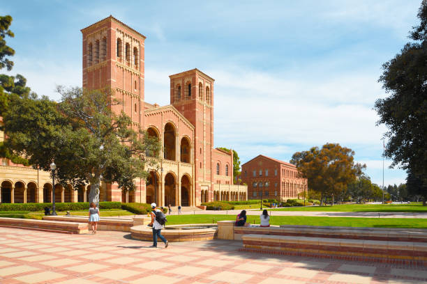 A view of the façades of Royce Hall and Haines Hall at University of California Los Angeles (UCLA) campus. Students are enjoying the sunny day. post secondary education stock pictures, royalty-free photos & images