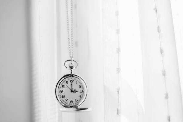 istock intage pocket watch and white drape background 1347617733