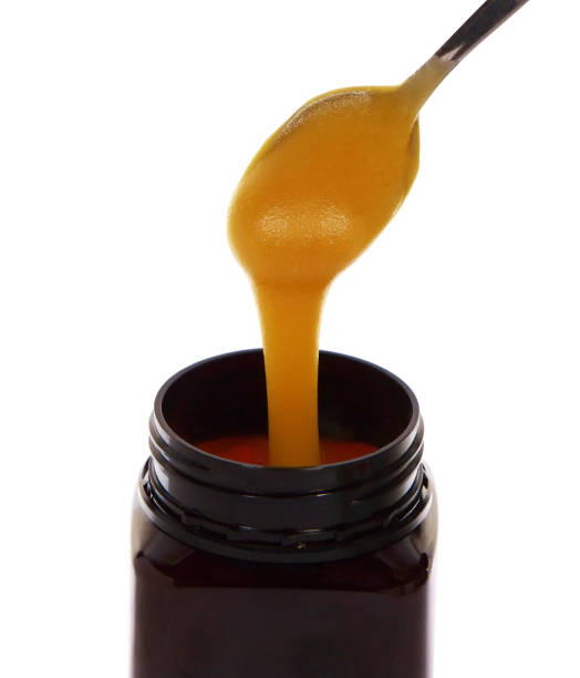 istock Manuka honey drains from a spoon isolated on white 1347617851