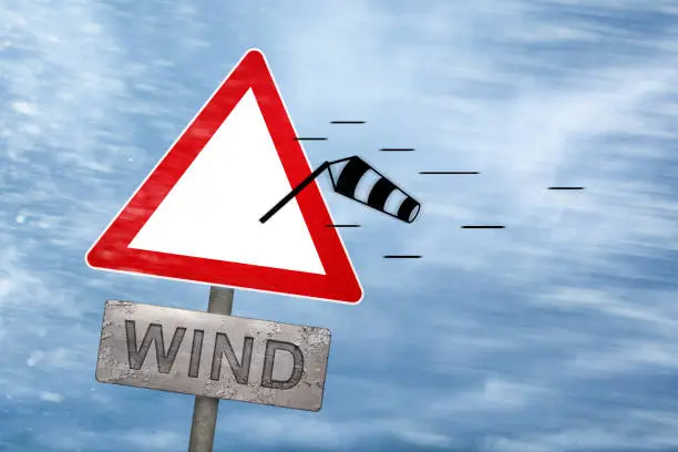 Photo of Wind warning sign getting blown away by a storm