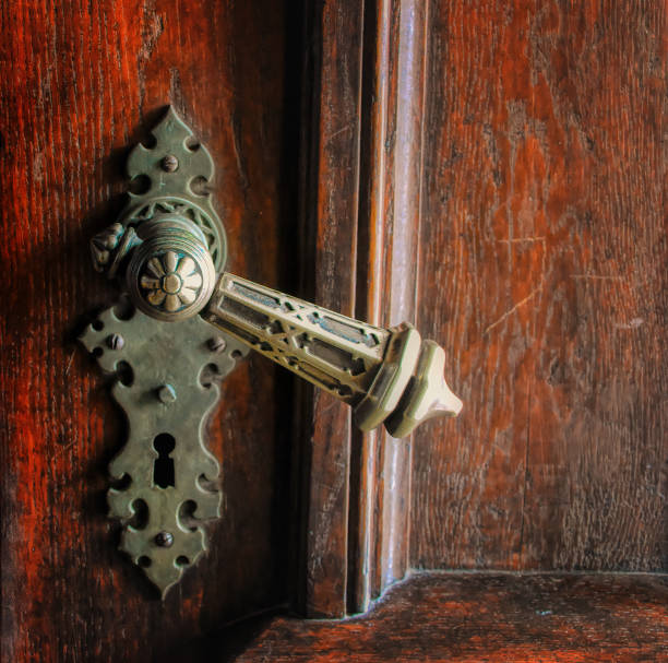 Vintage lock with handrail on wooden door background.