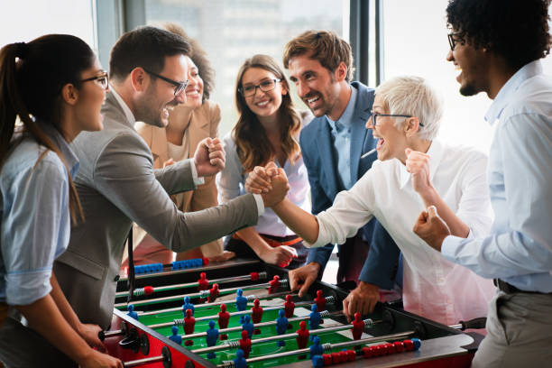 istock Coworkers playing table football on break from work 1347621171