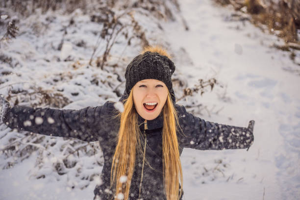 istock Woman has fun in winter, throws snow 1347623325