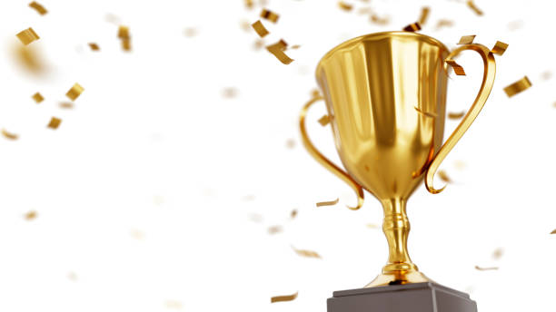 istock Winners golden cup and confetti isolated on white background 1347624542