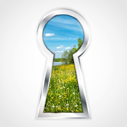 View of summer landscape with yellow flowers and blue sky in abstract silver keyhole