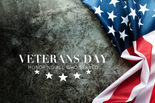 istock Veterans day. Honoring all who served. American flag on cement background 1347625565