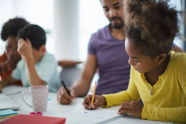 istock Family doing homework together. 1347625684