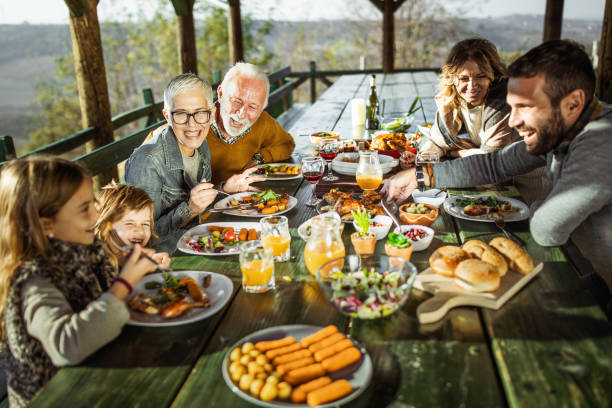 istock Happy extended family talking during lunch on a terrace. 1347626019