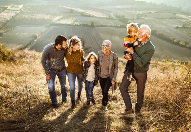 istock Happy multi-generation family talking while taking a walk on the field. 1347626048