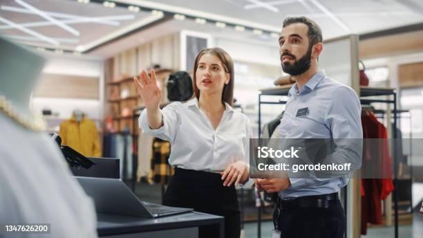 Clothing Store Businesswoman Uses Laptop Computer Talks To Visual Merchandising Specialist Collaborate To Create Stylish Collection Business Owners Fashion Shop Sales Manager Talks To Designer Stock Photo - Download Image Now